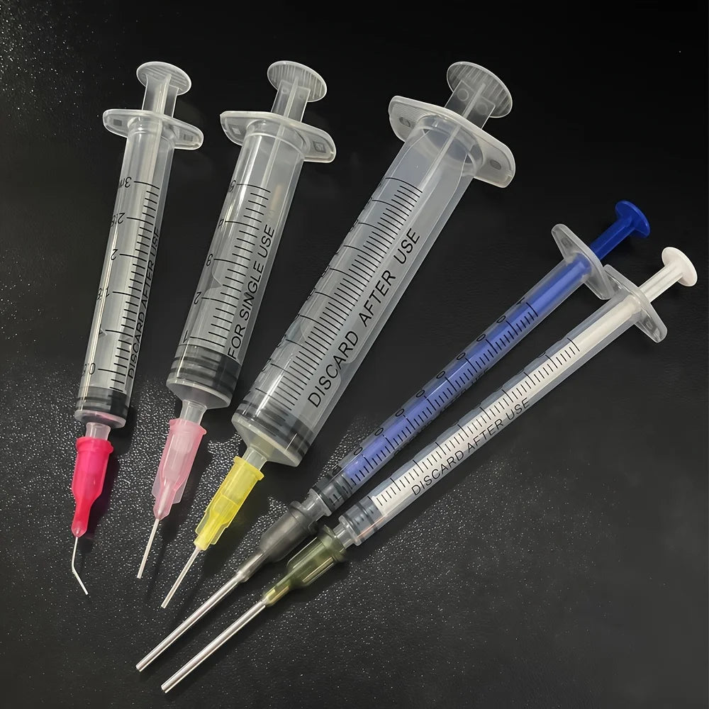 A set of precision laboratory syringes with various accessories, suitable for scientific laboratories to measure liquids.